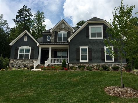 dark gray house with green metal roof|gray house with dark trim.